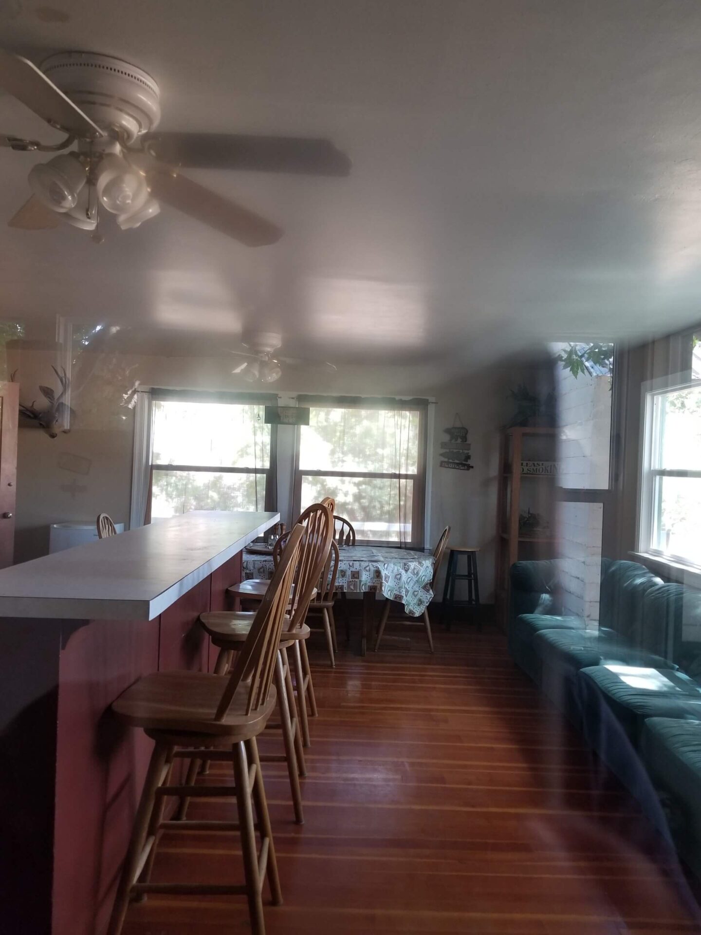 A kitchen with wooden floors and white walls.