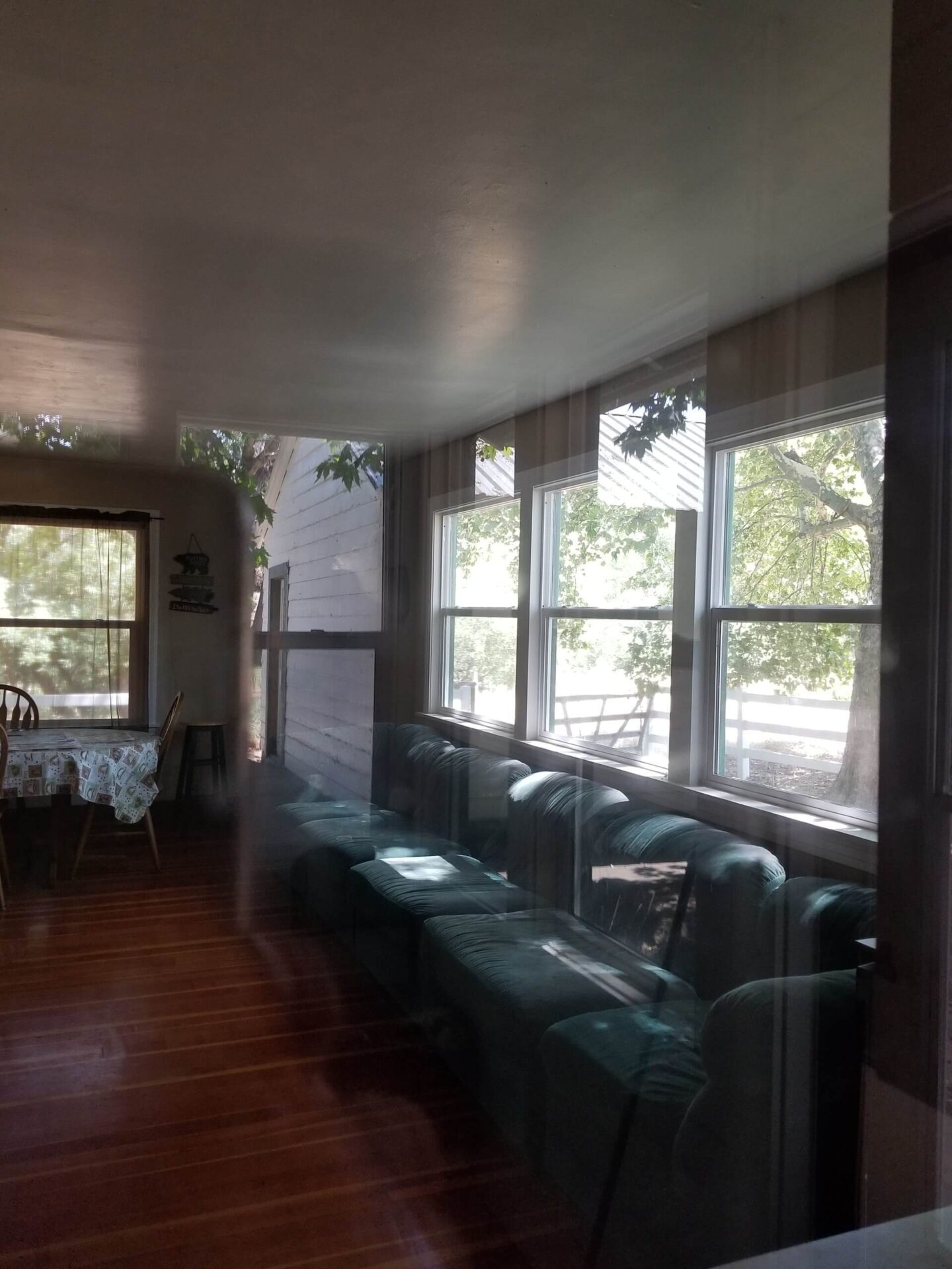 A room with many windows and tables in it